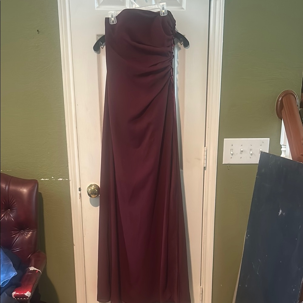 Elegant Strapless Burgundy Gown with crisscross ribbon on the side.